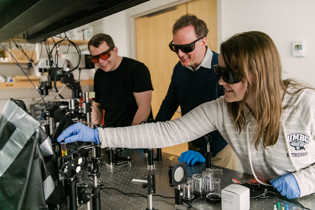 Matthew Pelton, center, works with students in his quantum photonics laboratory at UMBC.